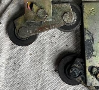 Sliding glass door rollers with failed bearings.